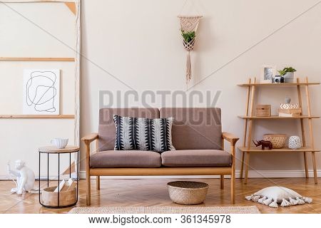 Interior Design Of Living Room With Stylish Brown Wooden Sofa, Macrame, Bookstand, Lamp, Coffee Tabl