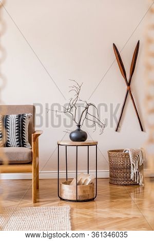 Interior Design Of Living Room With Stylish Brown Wooden Sofa, Macrame, Bookstand, Lamp, Coffee Tabl