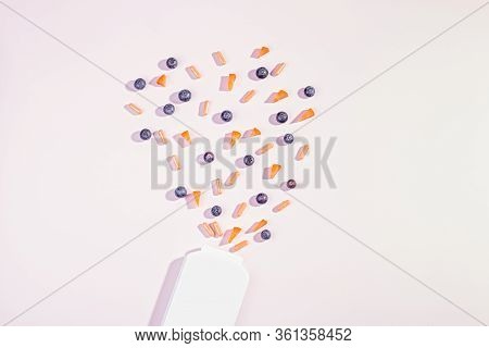 Vitamins And Supplements For Healthy Eyes On Pink Background. How To Maintain Good Vision Concept. B