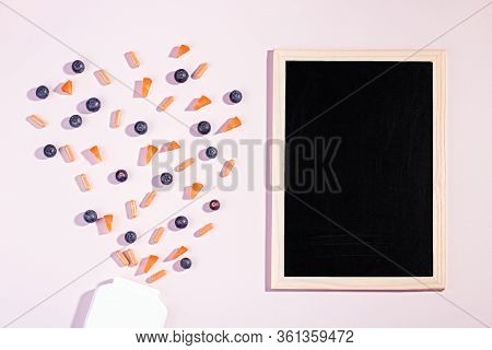 Vitamins And Supplements For Healthy Eyes On Pink Background. Blueberry, Carrot Pieces And Orange Ca
