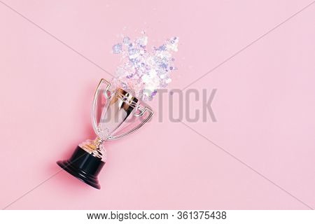 One Silver Winners Cup With Bright Sparkles On A Pastel Background. Lat Lay Style.