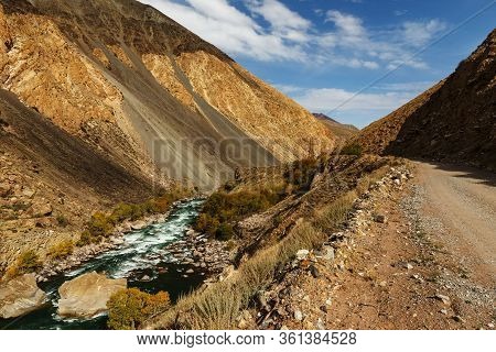 Mountain Road Along The Fast River, Kokemeren River, Jumgal District In Naryn Region Of Kyrgyzstan