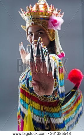 Young Lady Wearing Thai Tradition Southern Costume ,made From Colorful Beads,put Headdress On Her He