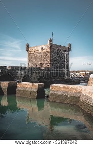 Sqala Du Port, A Defensive Tower At The Fishing Port Of Essaouira, Morocco Near Marrakech. Blue Sky 