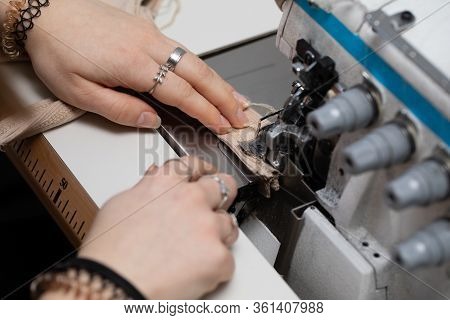 A Young Girl Learns To Sew On A Specialized Sewing Machine.