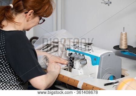 A Seamstress With Many Years Of Experience In Middle Age Works Quickly And Efficiently.
