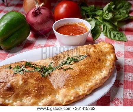 Fresh Stromboli Served With Tomato Sauce And Vegidables