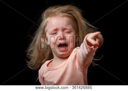 The Poor Little Girl Is Crying Hysterically, Pointing Her Finger At Her Abuser. Her Hair Is Tousled 