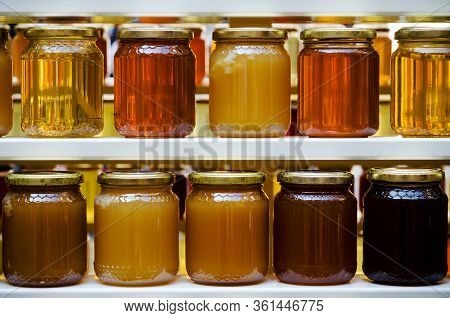 Jars Of Different Honey Varieties Stocked On A Shelf