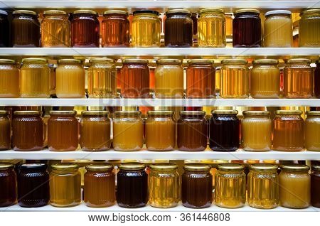 Jars Of Different Honey Varieties Stocked On A Shelf