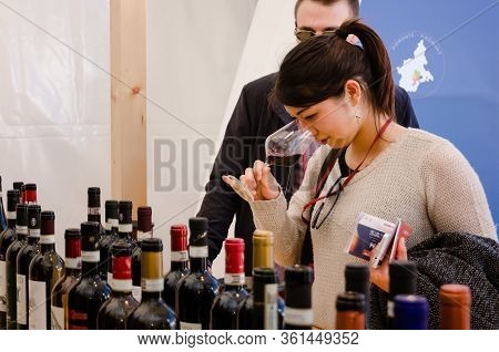 Alba, Italy - April 22, 2017 - Asian Woman Tasting Traditional Wines Of Piedmont At Vinum, Wine E Fo