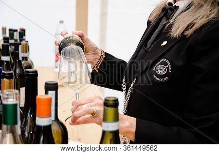 Alba, Italy - April 22, 2017 - Woman Sommelier With Traditional Wines Of Piedmont At Vinum, Wine E F