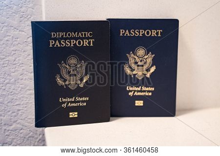 Two Passports For The United States Of America Citizens - A Diplomatic Passport (in Focus) And Regul