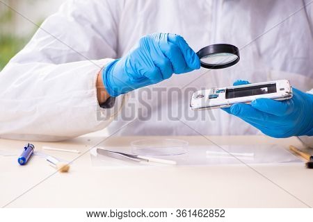 Male expert criminologist working in the lab for evidence
