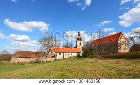 Kadov / Czech Republic - April 10, 2020: Gothic church of St. Wenceslas from the second half of the 13th century and castle in medieval village Kadov in Southern Bohemia.