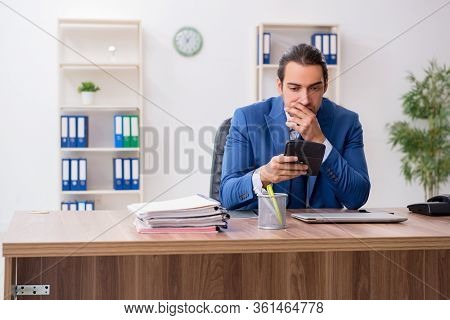 Young male businessman employee working in the office