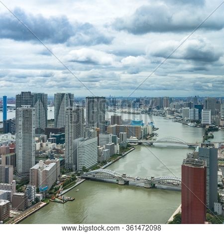 Tokyo Cityscape With Skyscrapers And Bridges Roads Over River. Aerial Drone View Of Tokyo Suburb Of 