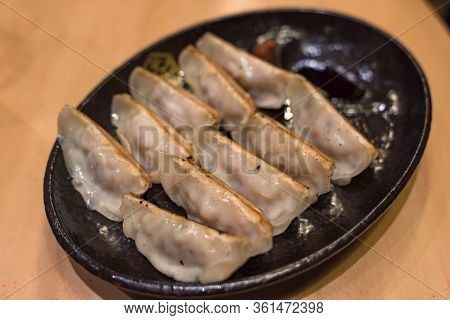 Traditional Japanese Gyouza Deep Fried Dumplings On Dark Plate. Japanese Cuisine Snack