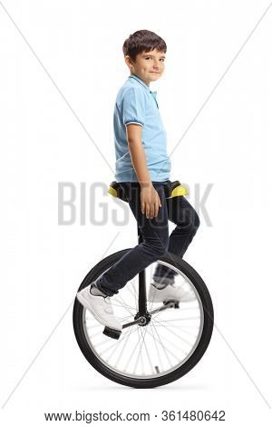 Full length shot of a boy riding a mono-cycle and looking at the camera isolated on white background