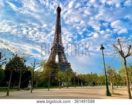 Scenic View Of The Eiffel Tower With Bright Blue Sky In Paris, France. Empty Parisian Streets During