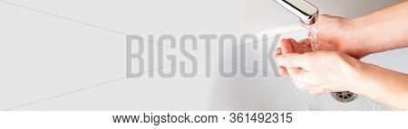 Banner Background. Washing Hands Under A Stream Of Water  In The Bathroom Over The Sink, There Is An