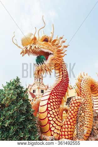 A Giant Golden Chinese Dragon That Holds A Green Glass Ball. Located In Wat Phra Thaen Temple, Thail