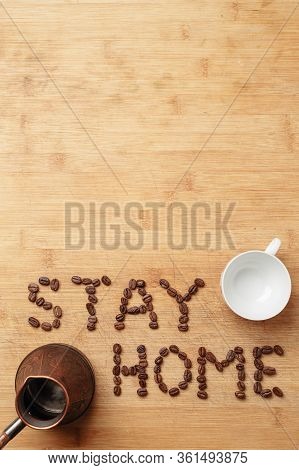 The Slogan Stay Home In The Form Of An Inscription Lined With Roasted Coffee Beans On A Warm Homemad