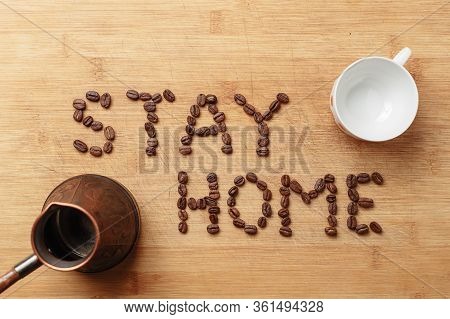 The Slogan Stay Home In The Form Of An Inscription Lined With Roasted Coffee Beans On A Warm Homemad