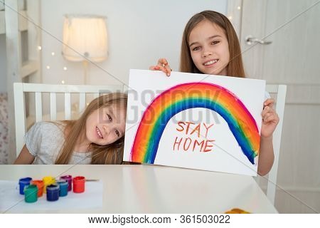 Small Girls Drawing On A White Sheet Rainbow And Write Stay Home. Flashmob Chasetherainbow.