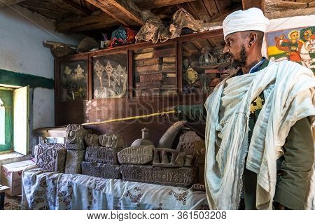 Yeha, Ethiopia - Feb 10, 2020: An Orthodox Priest Shows The Interior Of The Great Temple Of The Moon