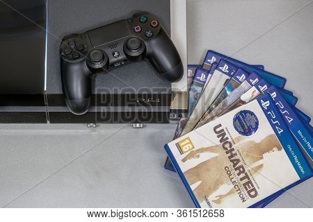 Thessaloniki, Greece - April 10 2020: Playstation 4 Game Titles Next To Device Top View. A Series Of