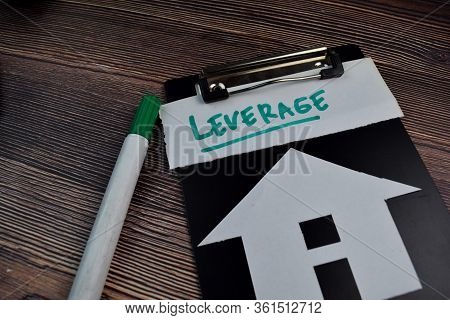 Leverage Write On Sticky Notes And House Made From Paper Isolated On The Table.