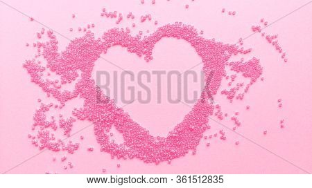 Hand Made Pink Heart Of Beads On Pastel Texture Background. Flat Lay With Copy Space. Stock Photo.