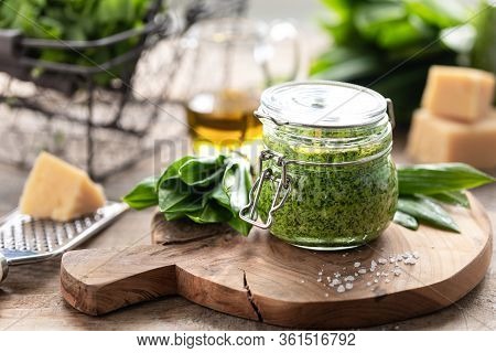 Wild Leek Pesto With Olive Oil And Parmesan Cheese In A Glass Jar On A Wooden Table. Useful Properti