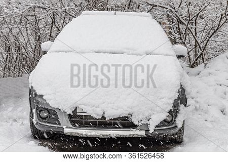 White Fresh Snow Is On A Silver Dirty Wet Car Outdoor In Winter