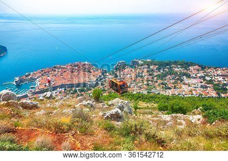 Aerial Panoramic View Of The Old Town Of Dubrovnik With Famous Cable Car On Srd Mountain On A Sunny 
