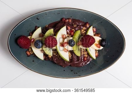 Acai Cerry Smoothie Bowl Topped With Raspberries, Bananas And Blueberries