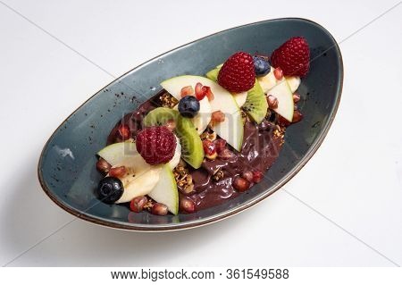 Acai Cerry Smoothie Bowl Topped With Raspberries, Bananas And Blueberries
