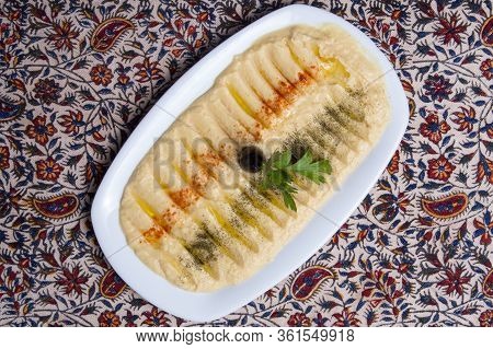 Homemade Iranian Hummus With Oil On A White Plate.