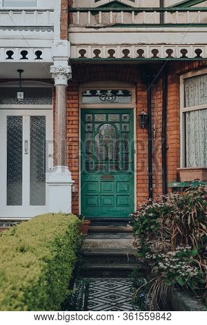 London, Uk - April 12, 2020: Stained Glass Green Wooden Door Of A Traditional Edwardian House In Lon