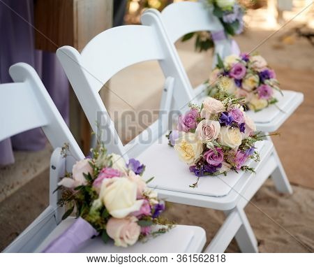 Flower Arraignment Decoration On Ceremony Chairs For Wedding Outdoor Setting
