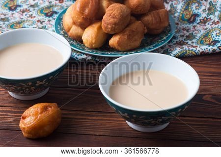 National Cuisine - Uzbek Baursaki In A Plate With A Traditional Pattern, On A Dark Wooden Table. Bas