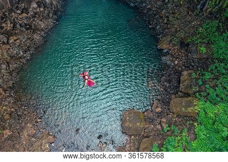 Girl Floating In The Lake Water Relaxing On Pink Inflatable Mattress In Blue Swimmingpool Remote Wor