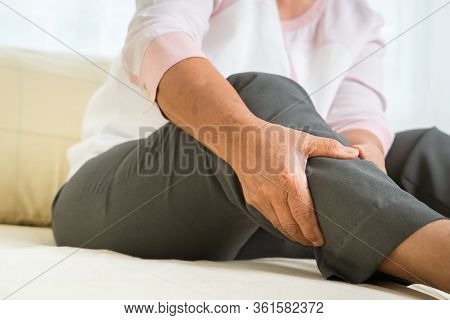Leg Pain Of Senior Woman At Home, Healthcare Problem Of Senior Concept