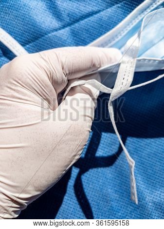 A Protective Glove With A Face Mask