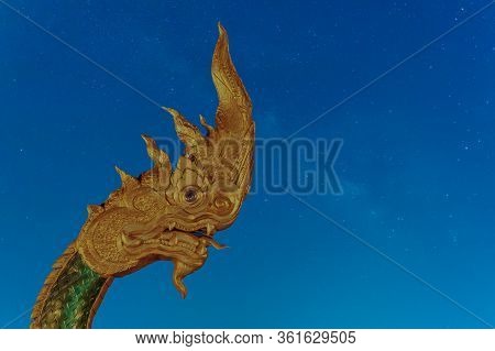 Phayanak Golden King Of Naga Heads  Statue   Isolated On Milky Way Background