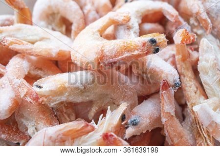 Frozen Big Shrimps Close Up. Raw Frozen Shrimp Background. Pile Of Frozen Shrimps Background