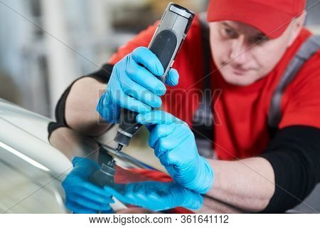 automobile windshield glass repair service. Car glass or chip crack repairing