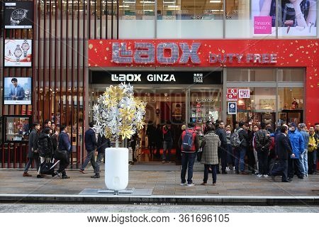 Tokyo, Japan - December 1, 2016: People Walk By Laox Duty Free Store At Ginza District Of Tokyo, Jap