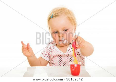 Cute Infant Girl Learining To Eat With Spoon